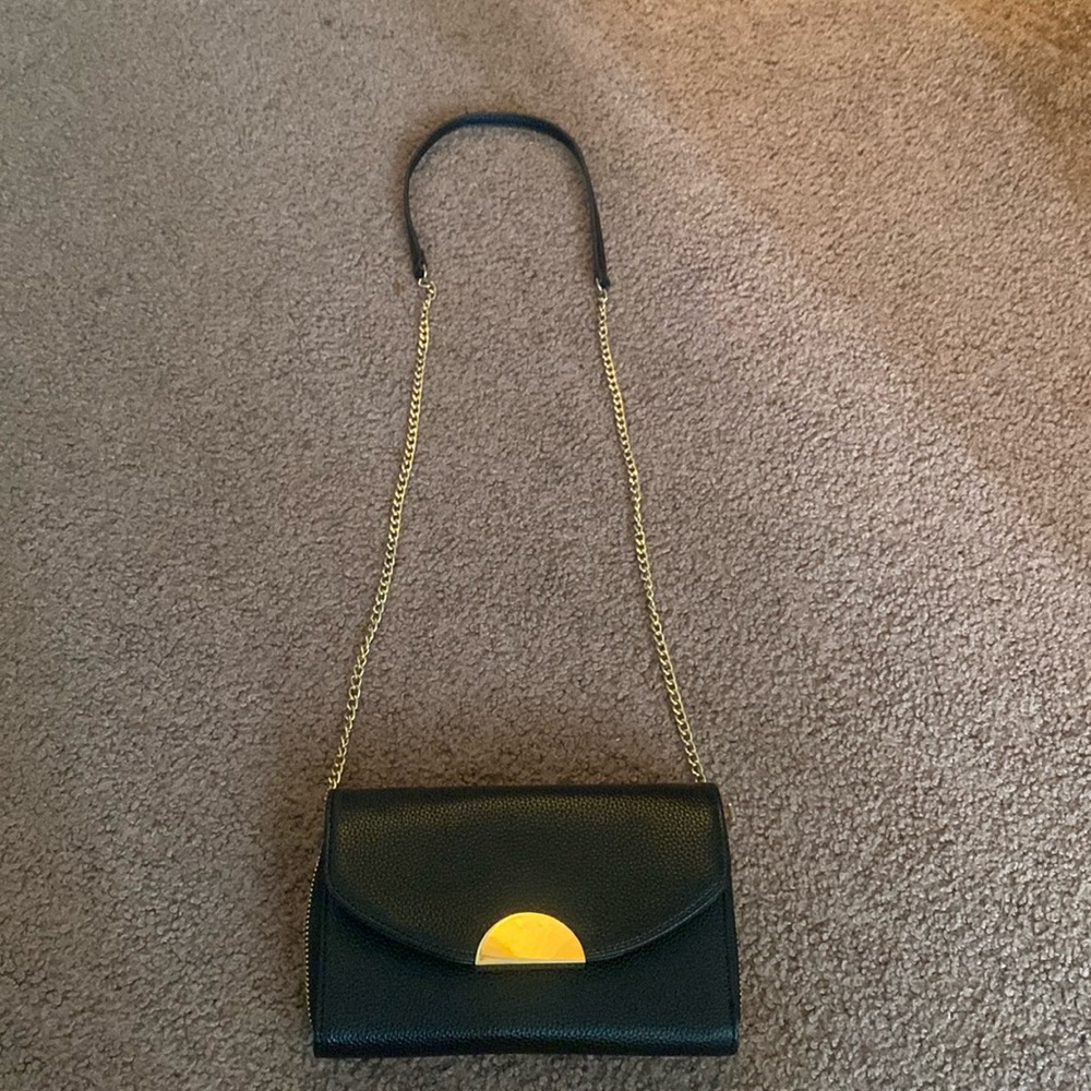 Black and gold purse with built in wallet.